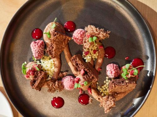 a plate of food with cherries and desserts on it at Pullman Munich in Munich
