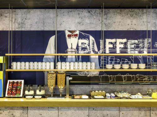 a kitchen with a counter with food on it at Ibis budget München Airport Erding in Erding