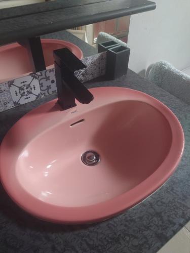 a pink sink in a bathroom with a counter at Studio Agde 5 min from the sea in Agde