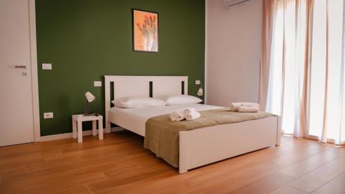 a bedroom with a bed with two towels on it at Zagara di Arancio e Limone Guesthouse in Cassibile