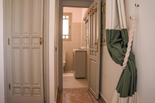 a hallway with a door to a bathroom with a sink at Casa Zitouni - Oasis with pool & private personal in Marrakech