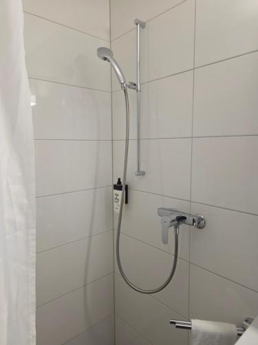 a shower with a shower head in a bathroom at Hotel Salvi in Kreuzlingen