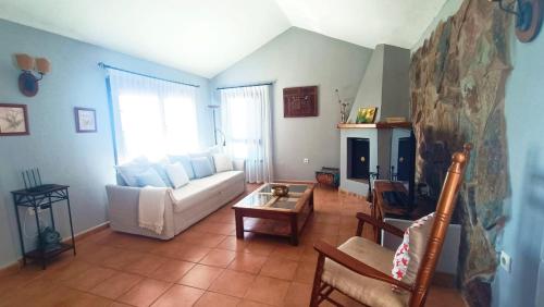 a living room with a white couch and a table at Villa Mery in Charco del Pino