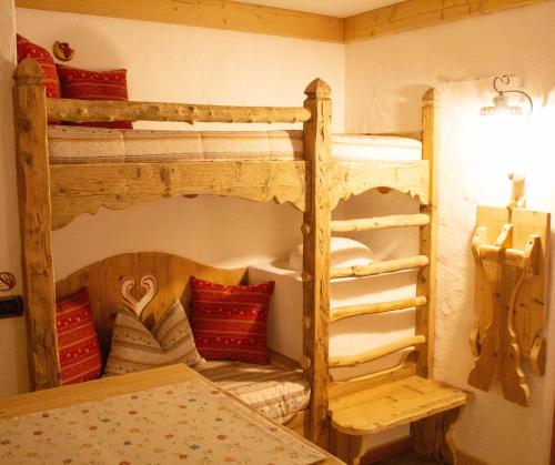 a room with two bunk beds and a table at Residence Lastè in Moena