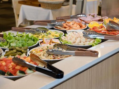 a buffet with many different types of food on a table at ibis styles Dax Centre in Dax