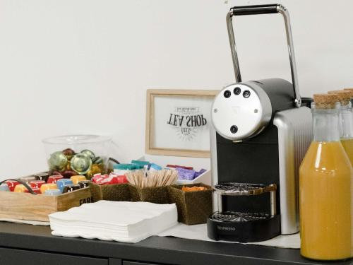 a counter with a coffee maker and some food at ibis styles Dax Centre in Dax
