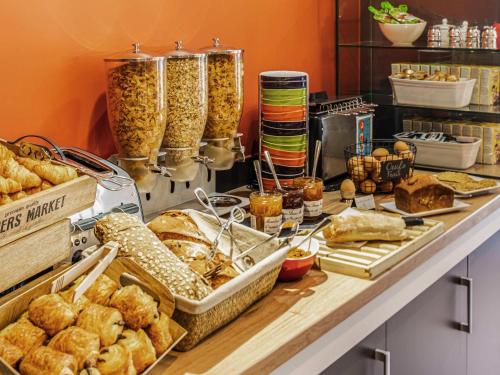 a buffet with various types of bread and pastries at Ibis Styles Reims Centre in Reims