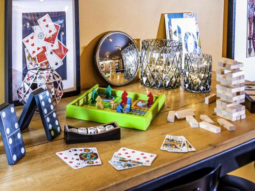 a table with playing cards and other items on it at Ibis Styles Reims Centre in Reims