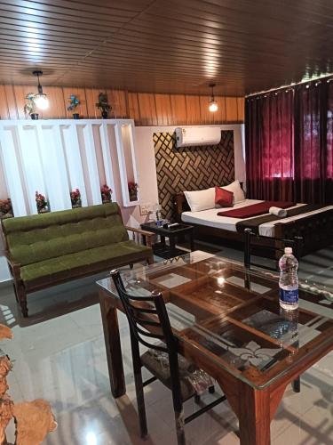 a living room with a couch and a table at Tea vista holiday home in Kalpetta