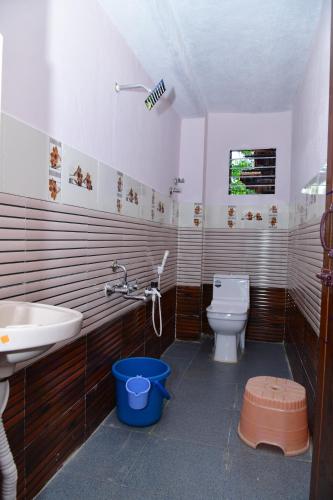 a bathroom with a sink and a toilet at SugarLeaf Homestay - Home Food & Near to Tourist Places in Sakleshpur
