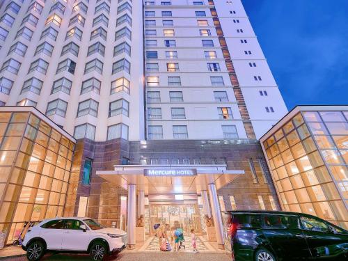 a white car parked in front of a building at Mercure Okinawa Naha in Naha