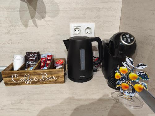 a coffee bar with a coffee pot and a box of coffeeaband at Borovets Gardens Forest STUDIO A3 in Borovets