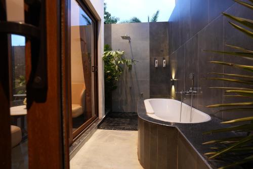 a bathroom with a sink and a bath tub at HF Pool Resorto in Chennai