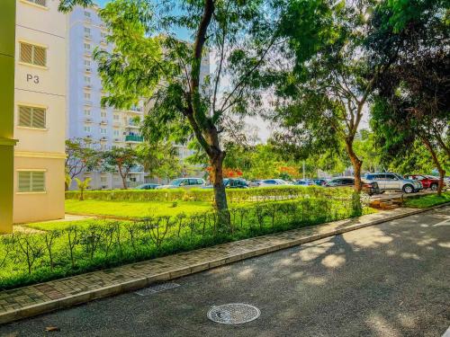 a street with a fence and a park with cars at Remarkable 5-Bed Apartment in Kilamba - Luanda in Luanda