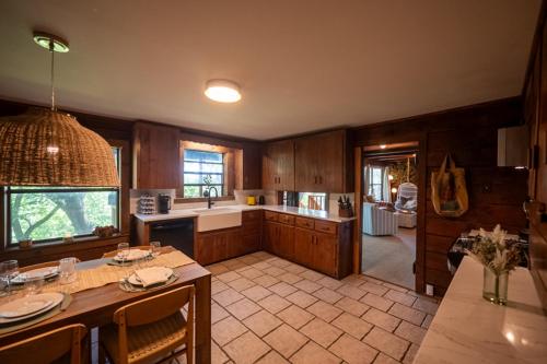 a kitchen with wooden cabinets and a table with a counter top at The Woodsman Lodge in Eureka Springs