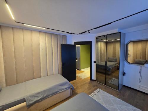 a bedroom with a bed and a sliding glass door at Apartments Lura in Peje