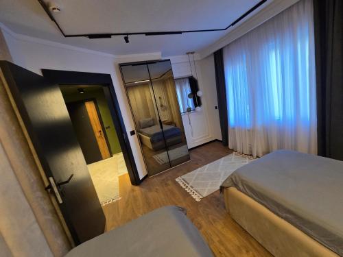 a hotel room with a bed and a mirror at Apartments Lura in Peje