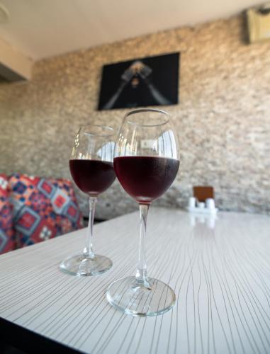 two glasses of red wine sitting on a table at Airport Black Sea Hotel & Restaurant in Arnavutköy