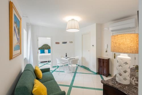 a living room with a green couch and a table at Torre Paradiso in Minori