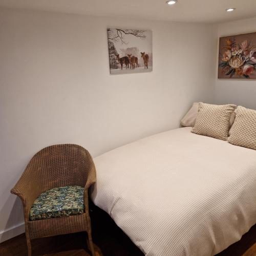 a bedroom with a bed and a chair at Welcoming ensuite bedroom in Wolverhampton