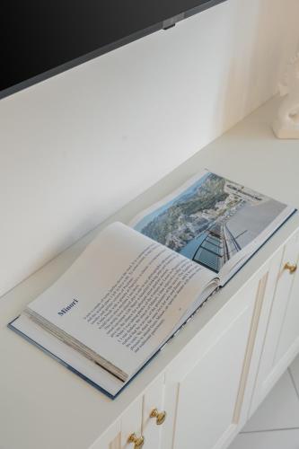 an open book sitting on top of a kitchen counter at Torre Paradiso in Minori