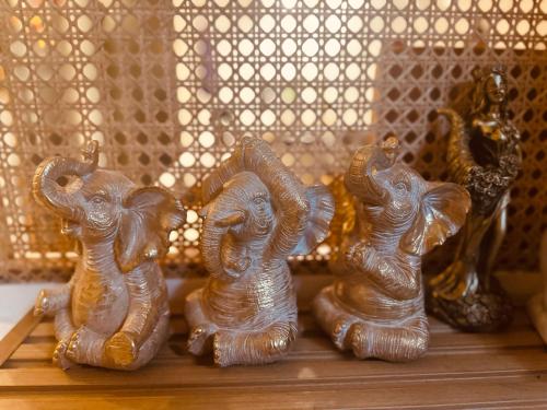 a group of elephant figurines sitting on a shelf at Terravive in Manila