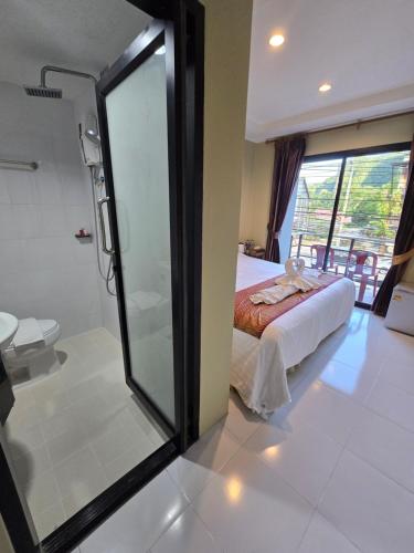 a bathroom with a shower and a bed in a room at Ao Nang 9 Rooms and Stay in Ao Nang 