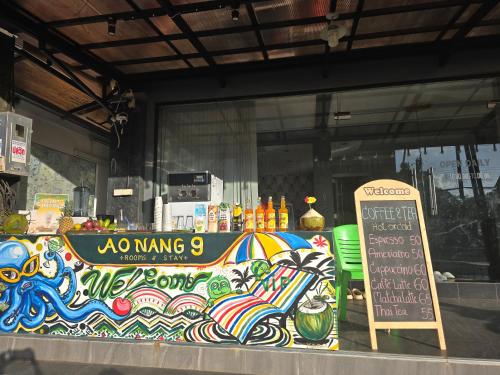 a store window with a colorful counter with an umbrella at Ao Nang 9 Rooms and Stay in Ao Nang 