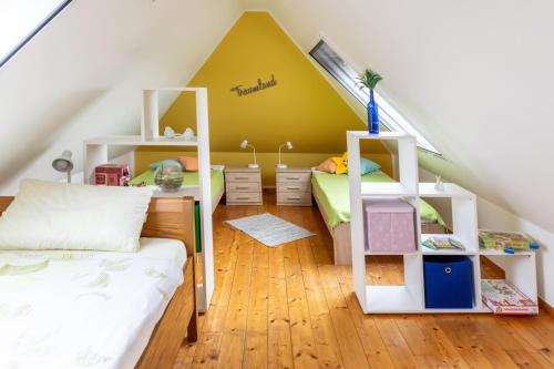 a room with two bunk beds and a yellow wall at Ferienwohnungen Schoofs in Kalkar