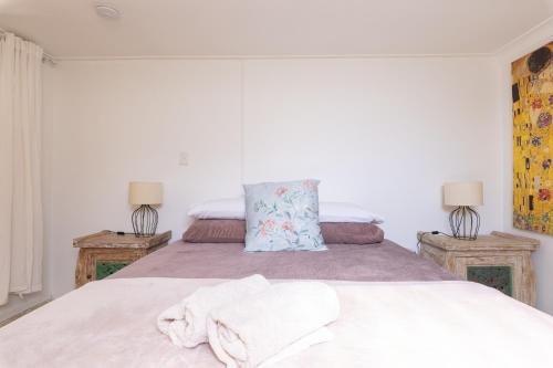 a bedroom with a bed with towels on it at Zen Escape Guest House " Location 1" - Three listings - Romantic Escape, Cozy Delight, Oasis Suite in Brisbane