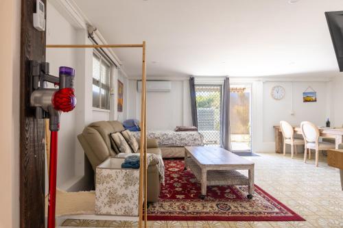 a living room with a couch and a table at Zen Escape Guest House " Location 1" - Three listings - Romantic Escape, Cozy Delight, Oasis Suite in Brisbane