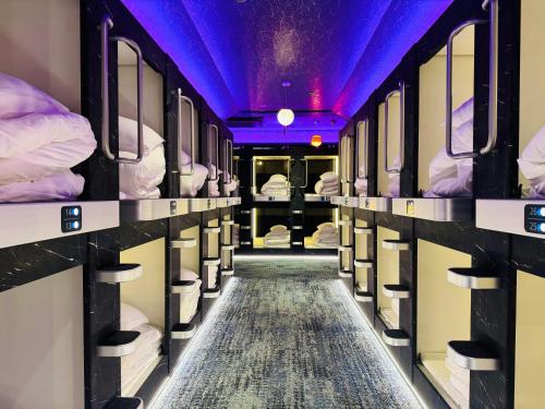 a corridor of a train with bunk beds at Capsule Hostel Beppu Tower in Beppu