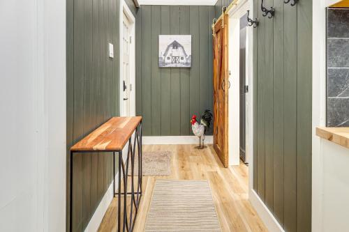 a hallway with green walls and a wooden counter at Luxe Stable Suite Farm Stay in Lebanon! in Lebanon