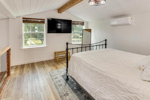 a bedroom with a bed and a flat screen tv at Luxe Stable Suite Farm Stay in Lebanon! in Lebanon