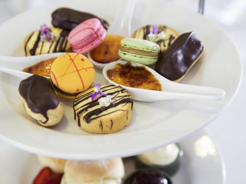 a bunch of donuts on a white plate at Novotel Newcastle Beach in Newcastle