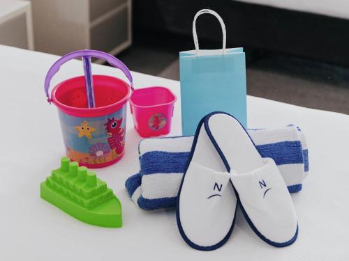 a table with a pair of flip flops and a bag at Novotel Newcastle Beach in Newcastle