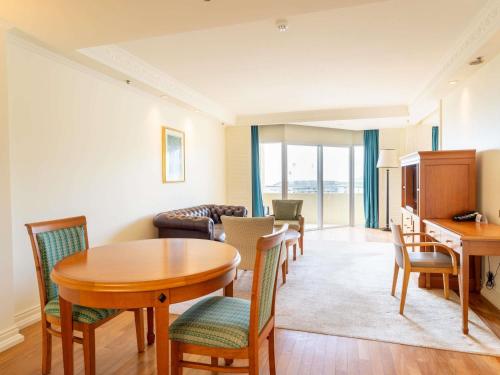 a living room with a table and chairs at Pullman Cairns International in Cairns