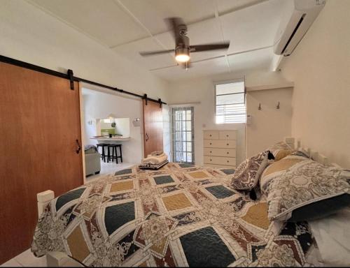 a bedroom with a large bed in a room at Maple cottage in Bridgetown
