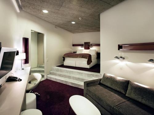 a hotel room with a bed and a couch at Ibis Styles Stockholm Odenplan in Stockholm