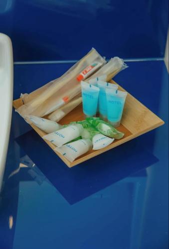 a tray with chopsticks and plastic cups on a table at Astounding Sea View Aparthotel In Orbi City Batumi in Batumi