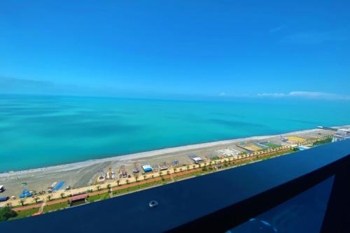 an aerial view of a highway next to the water at Astounding Sea View Aparthotel In Orbi City Batumi in Batumi