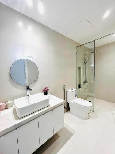 a bathroom with a sink and a toilet and a mirror at Classic homestay in Thôn Trường Giang