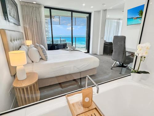 a bedroom with a bed with a view of the ocean at Oracle 11th floor Tower 1 - GC Getaways in Gold Coast