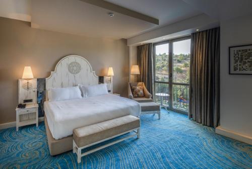 a bedroom with a large bed and a large window at Ramada Plaza by Wyndham Mardin in Mardin