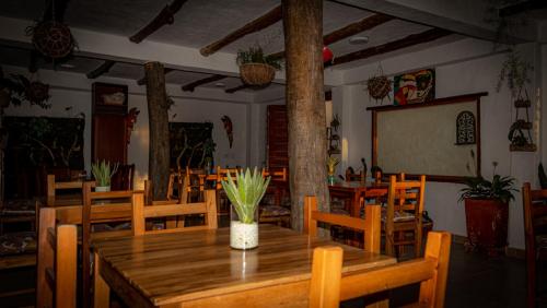 a dining room with a wooden table and chairs at Hotel Boutique Santa Clara Mesa de los Santos in Los Santos