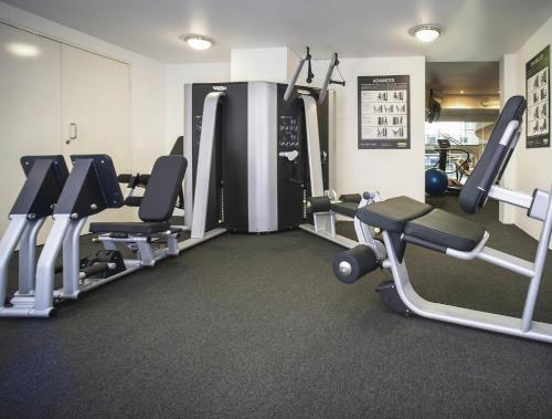 a gym with several treadmills and cardio machines at Pullman Quay Grand Sydney Harbour in Sydney