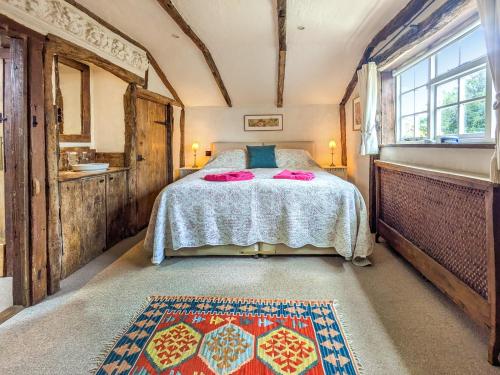 a bedroom with a bed and a large window at Stable End in Halesworth