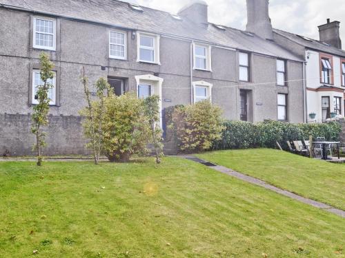 a large house with a lawn in front of it at Minallt in Nefyn