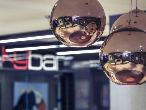 two silver balls hanging from the ceiling of a store at Mercure Brisbane King George Square in Brisbane