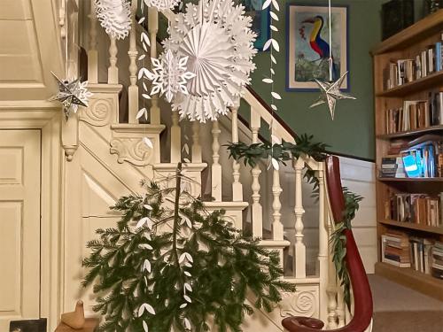 a staircase with a christmas tree in a room at Hemblington Hall Arts And Leisure Ltd in South Walsham